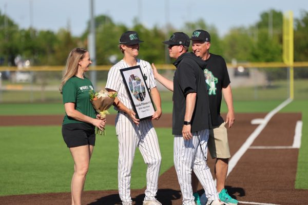 On May 12 senior Dakota Pittman smiles after receiving his gift from coaches and team on senior night.
