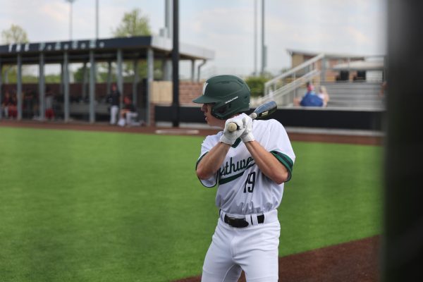 Practicing to hit, Sophomore Vincent Weber prepares on the side before hitting at the baseball game against BVW on May 14.