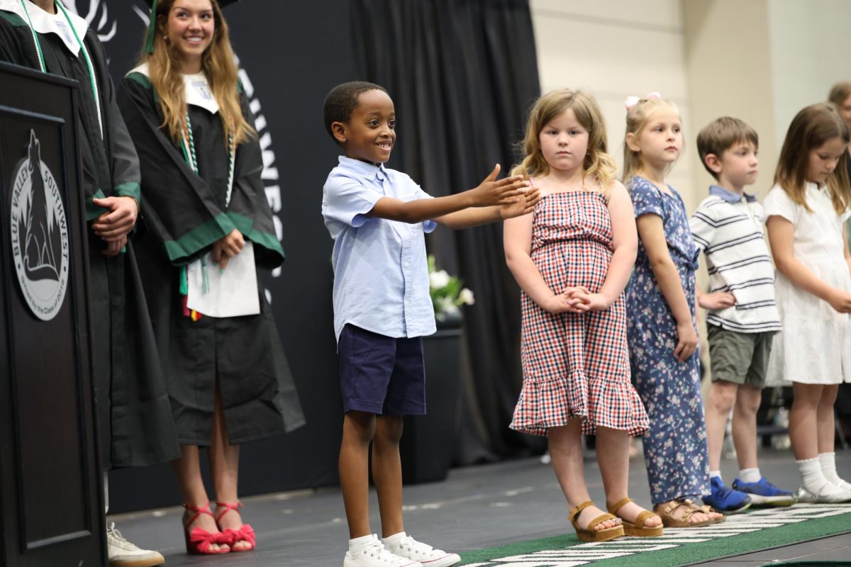 Arms Out, Honorary Kindergarten speaker gives words of wisdom to the graduating class on Class day on May 16