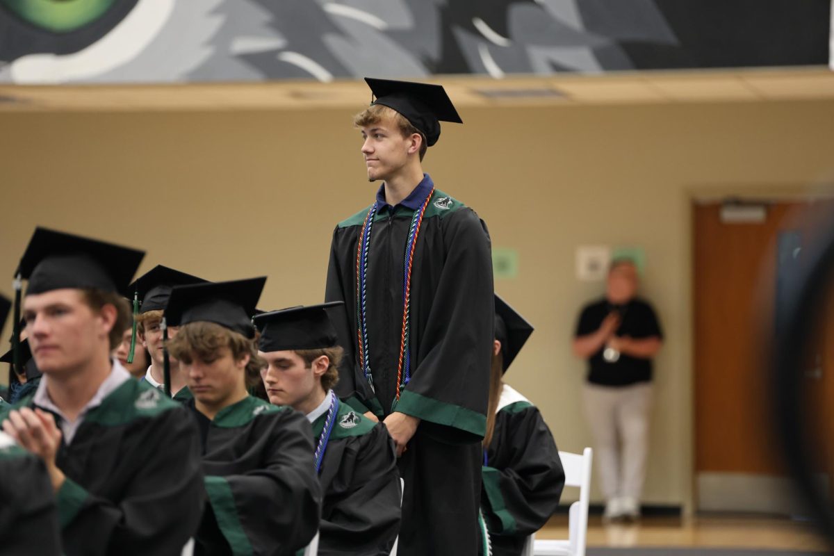 Standing up, Senior Parker Sloan is up as he is honored for an award on May 16.
