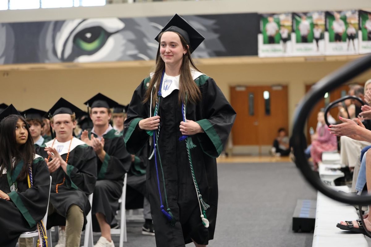 Walking to stage, Senior Lily Unruh is awarded the Leochner Memorial Scholarship on Class Day on May 16.