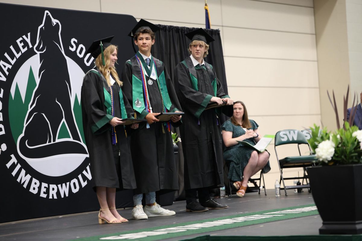 Plaque in hand, Senior Andrew Woirhaye receives the Protect the Pack award on May 16 at Class Day. 
