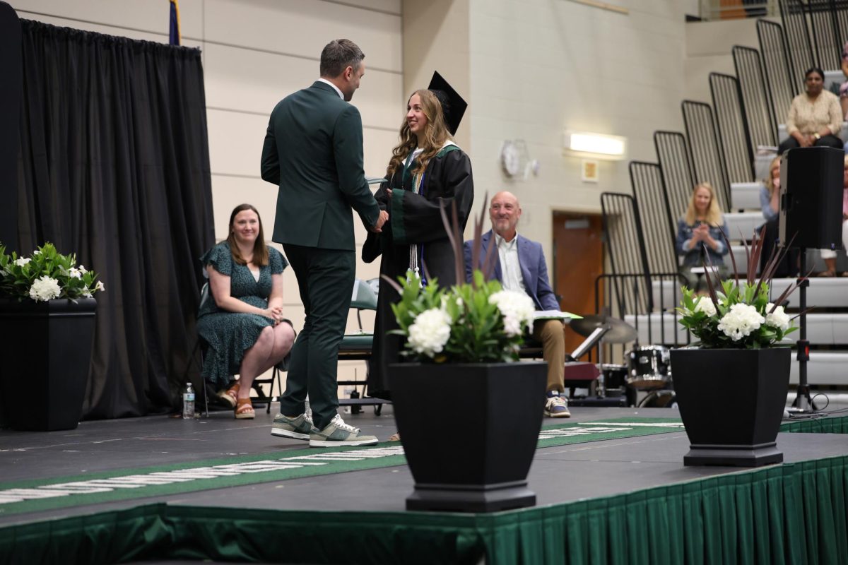 Shaking hands, Principal Tyler Alexander awards senior Alana Lewis with the BVSW legacy award at Class Day on May 16. 
