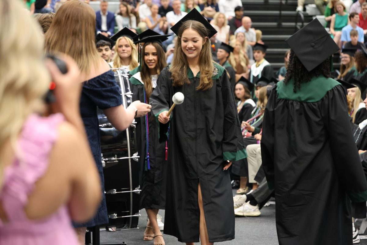 Mallet in hand, Senior Lindsay Dill hits the honorary drum stating that her high school time is over at Class Day on May 16.