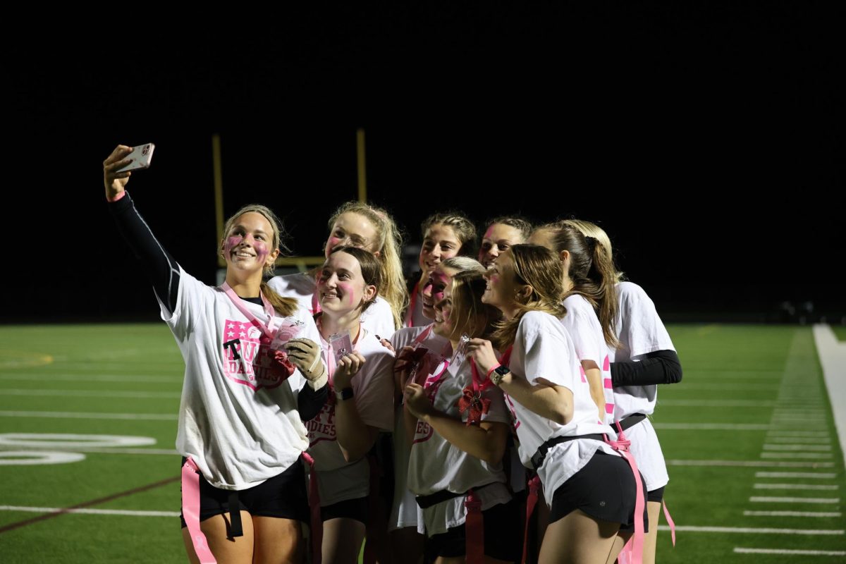 Posing for the camera, winning senior team the “Tuff Daddies” pose for a selfie after winning the Powderpuff Games on April 27.