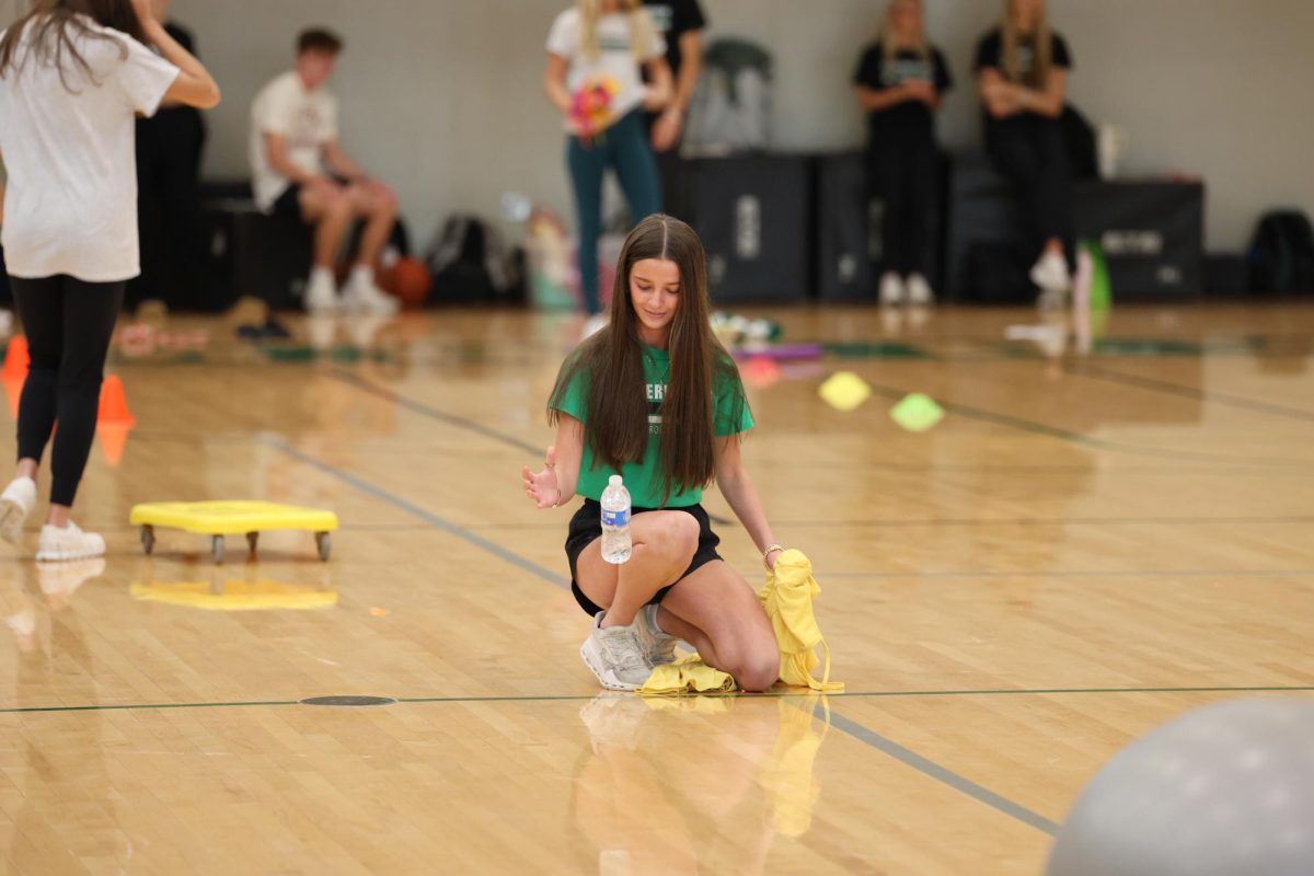 Freshman Taylor Morrow bottle flips the water bottle during the assembly game. 