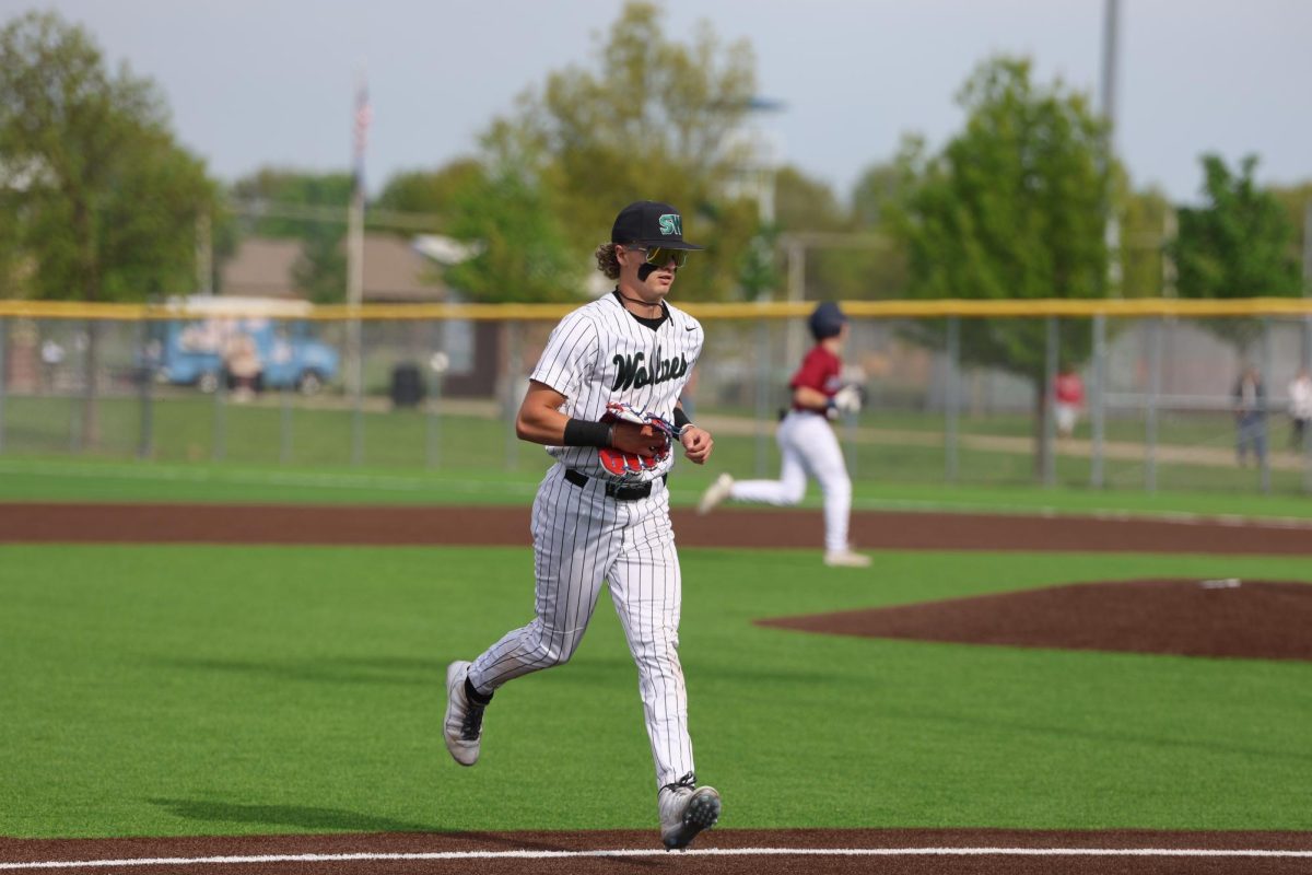 Sophomore Brayden Shannon runs off the field to the dugout. 