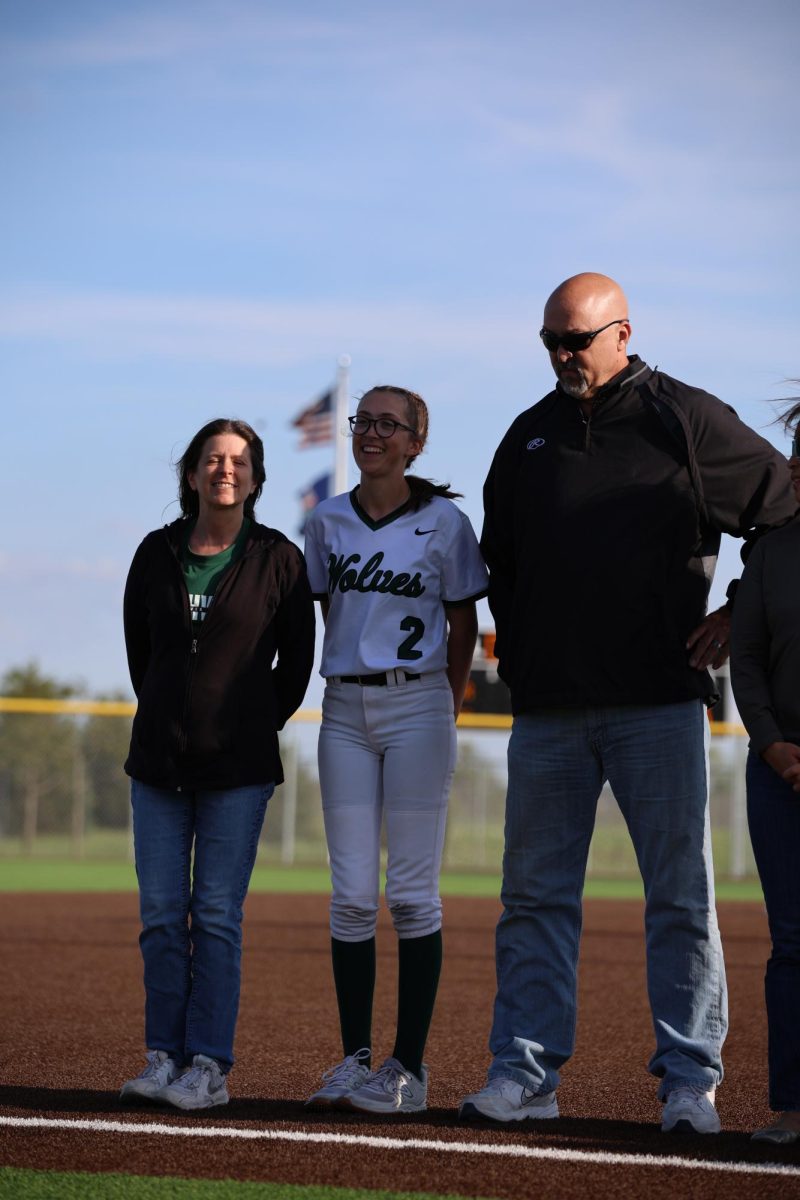 Senior Mara Somogye smiles with her parents. 
