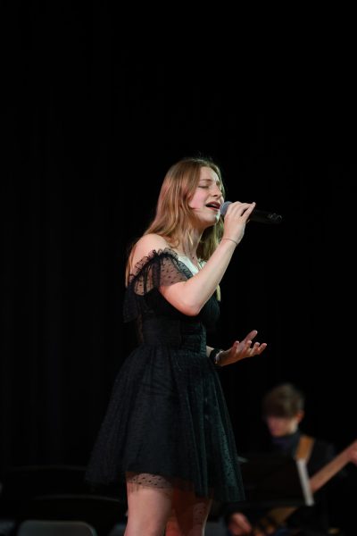 Senior Emily Chipak is second to sing her solo, "The Soprano & Midnight Wonderings" during the concert on May 6.