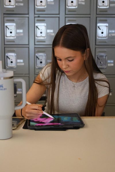 On the app Pro-Create, junior Allie Freeman finishes up a digital piece of artwork for her drawing I class on May 13.