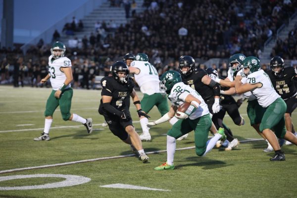 In a sprint, junior Cylis Luther defends the ball on Sept. 5 during the football game.