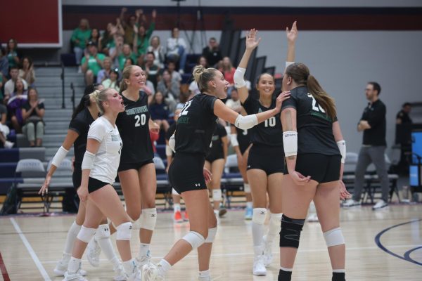Senior Willow Weninger and senior Sofia Ricci celebrate a point against  Blue Valley West on Aug. 30