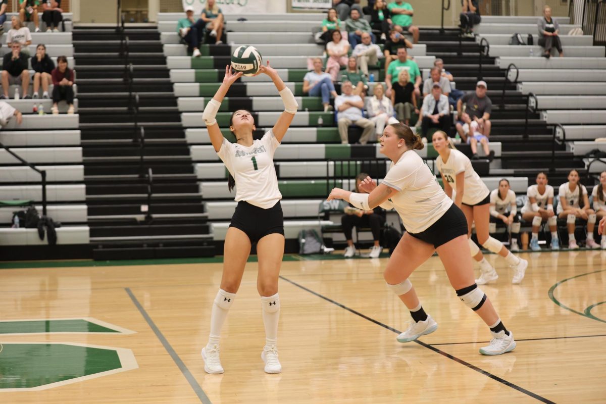 Senior Caitlin Shao sets the ball to Senior Sofia Ricci in the game against Lee's Summit on Sept. 3