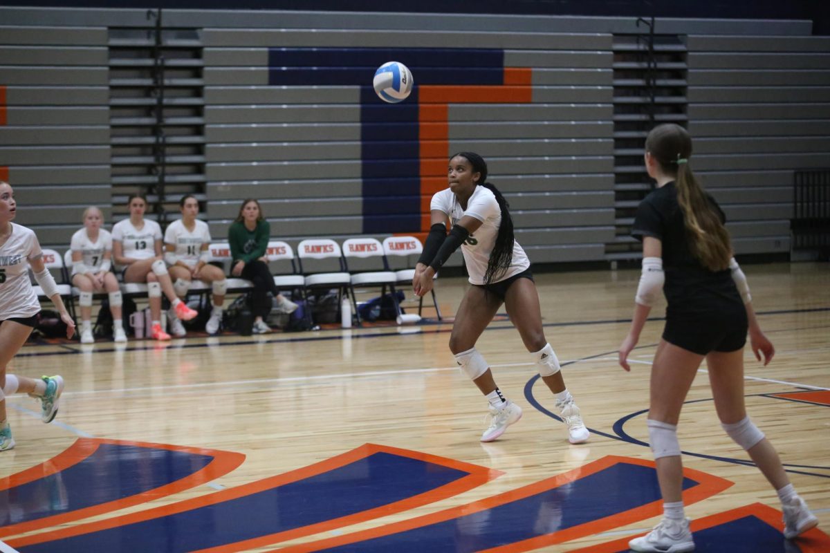 Focused, sophomore Evonna Sutter passes the ball in serve receive during the game against Olathe East on Oct. 21.