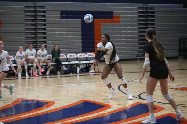 Focused, sophomore Evonna Sutter passes the ball in serve receive during the game against Olathe East on Oct. 21.