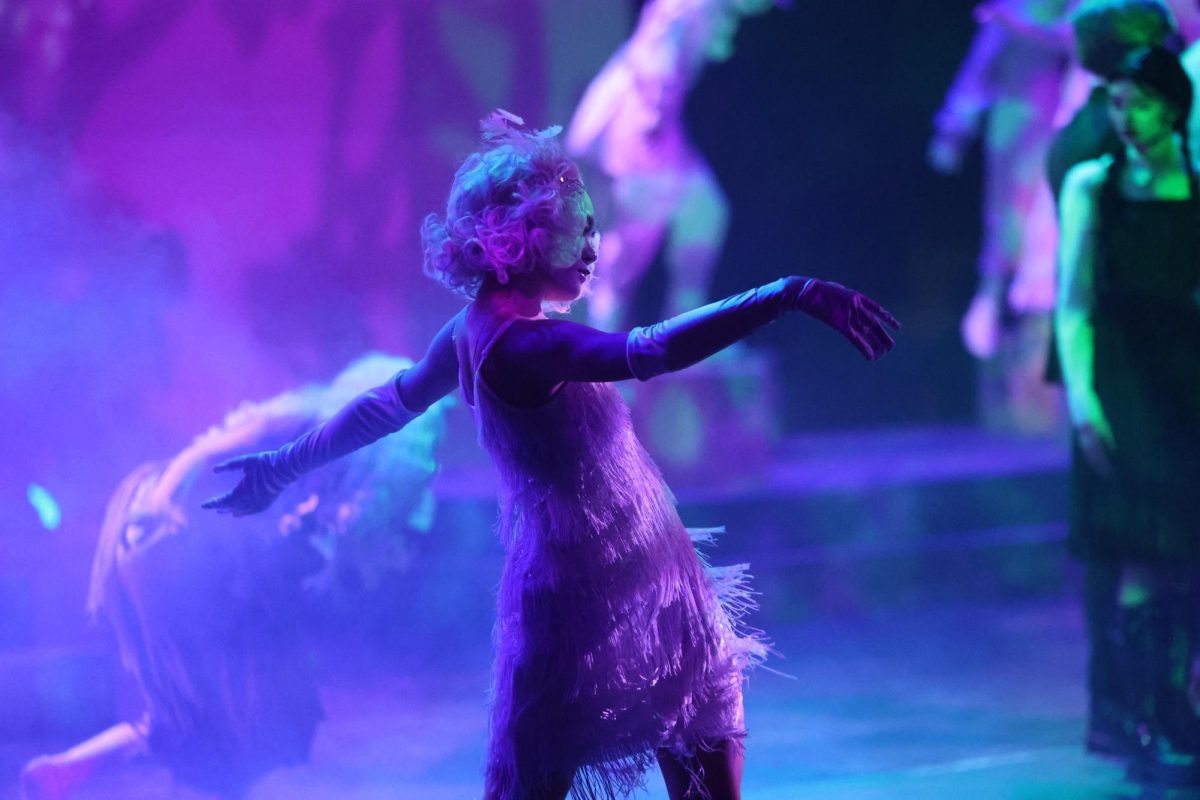 Facing the audience, freshman Isabel Moon dances to the music during a dress rehearsal on Nov. 11.