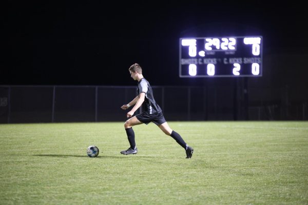 Focused on the ball, senior Wesley Abraham gets ready to kick the ball during the quarterfinal game against Piper on Nov. 3.