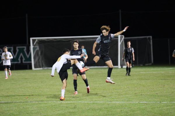 In the air, senior Gavin Gryp attempts to kick the ball on Nov. 5 in the soccer game against Newton.