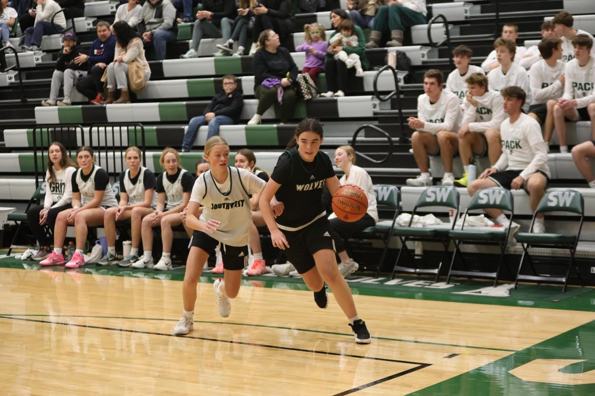 Defending her opponent, freshman Avery Hollon dribbles down the court during hype night on Dec. 3.