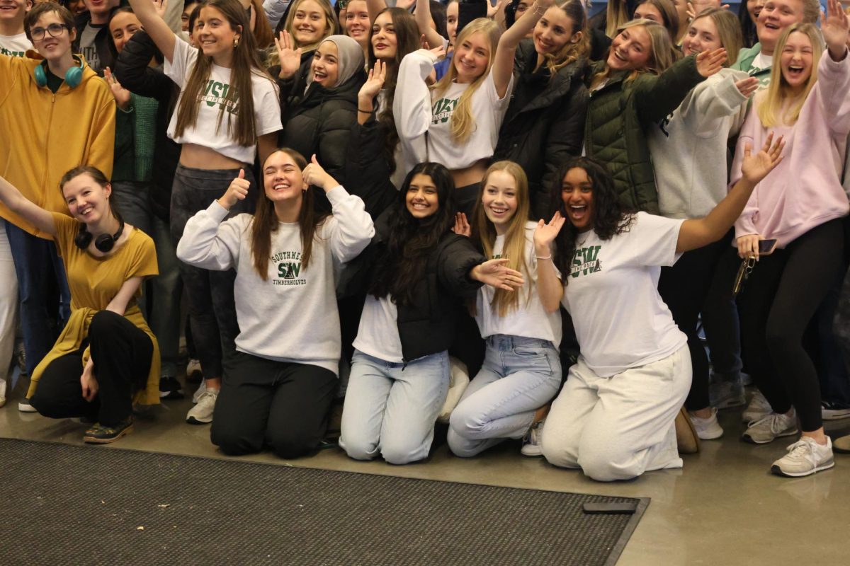 Smiles on their faces, seniors Arden Harms, Joanna Suku, Brielle Widman and Srihansika Penugonda pose for a picture during the senior breakfast on Dec. 4.