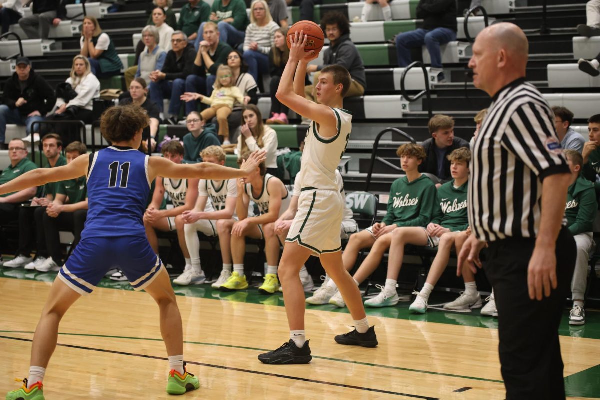 Focused in, sophomore William Abraham looks for a teammate at the varsity boys basketball game against Gardner Edgerton on Dec. 16.