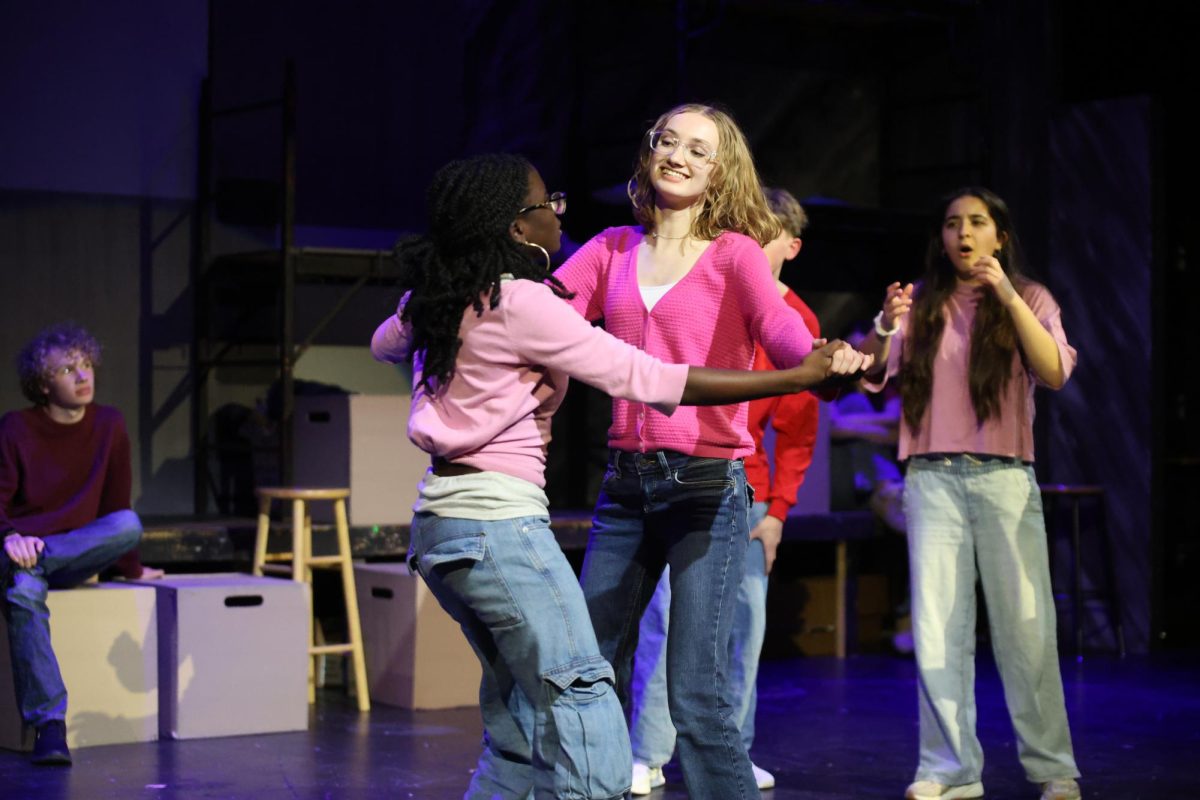 Smiling, junior Aliyah Lawrence dances with junior Dara Onibonoje during the improv show on Feb. 25.