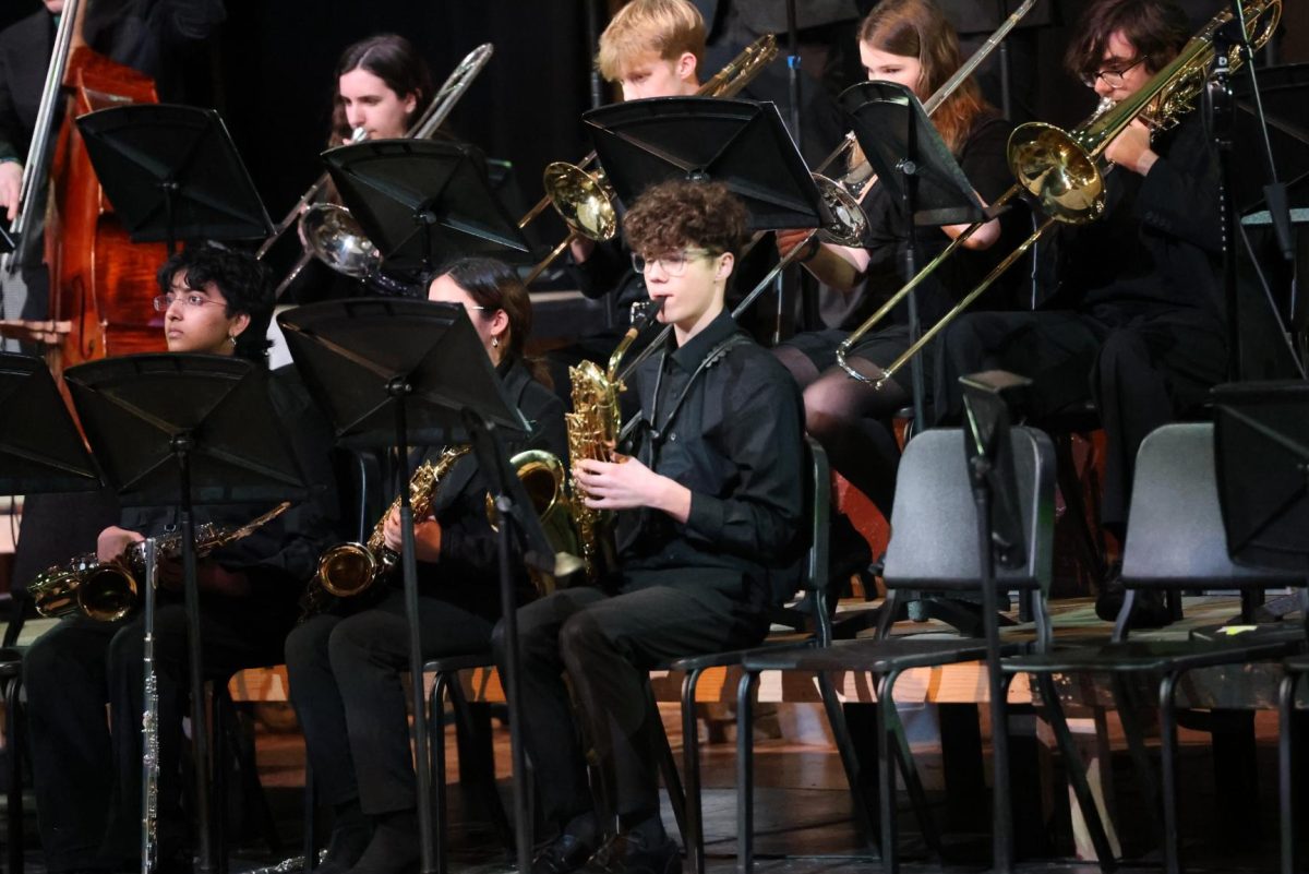 With the band, freshman Ryder Martin plays the saxophone at the jazz band concert on Feb. 17.
