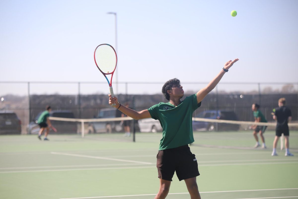 Mid-serve, senior Sanay Patel plays against Spring Hill on March 25.