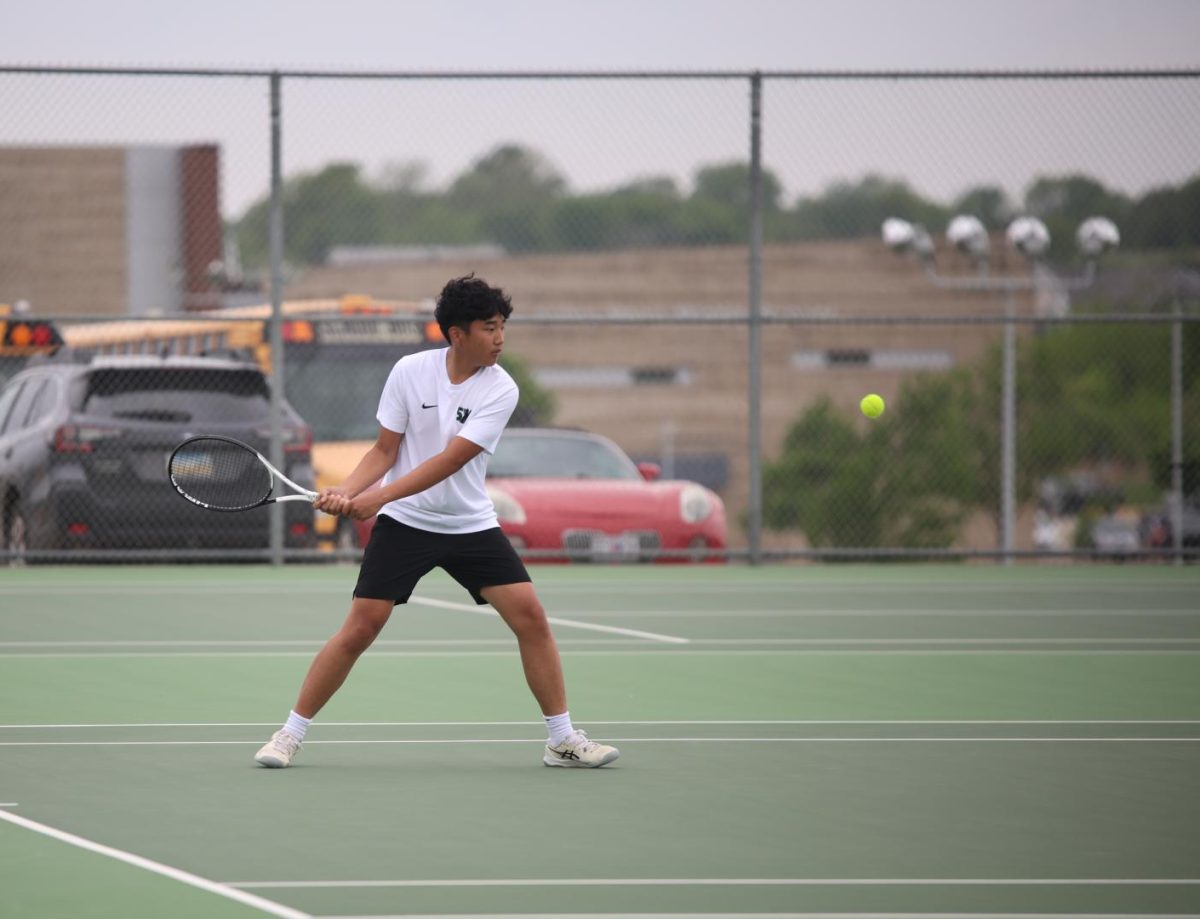Ready for the return, senior Daniel Chang prepares to hit the ball on April 23. 