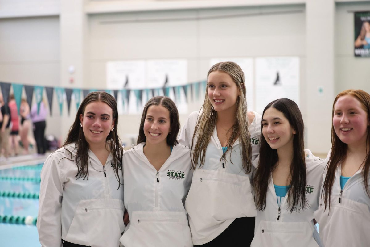 Smiling at the camera, seniors Natalie Chandler, Annalisa Pini, Willow Weninger, Sophia Taghizadeh, and Ella Meraz take a picture during the Girls Swim and Dive Senior Night on April 28. 