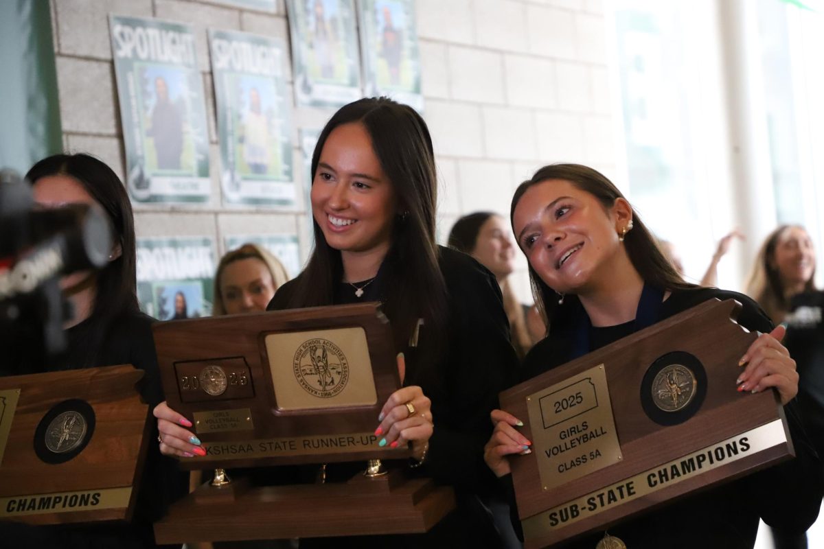 With substate trophies, Senior Hailie Vaughn and junior Lauren Taloney smile during the lip dub on April 1.