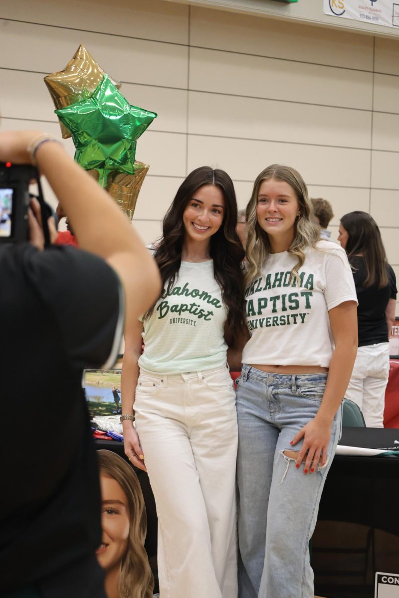 Posing, senior Addison Jones smiles for a picture during the athletic signing ceremony on April 28. Jones committed to playing girls golf at Oklahoma Baptist University. 