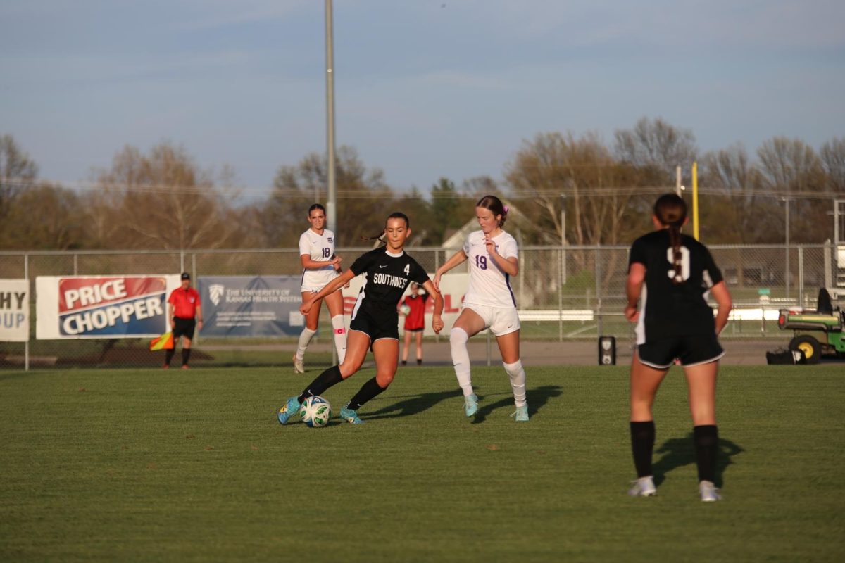 Arms out, senior Allie Freeman looks for an opening to pass the ball during a game on April 7.