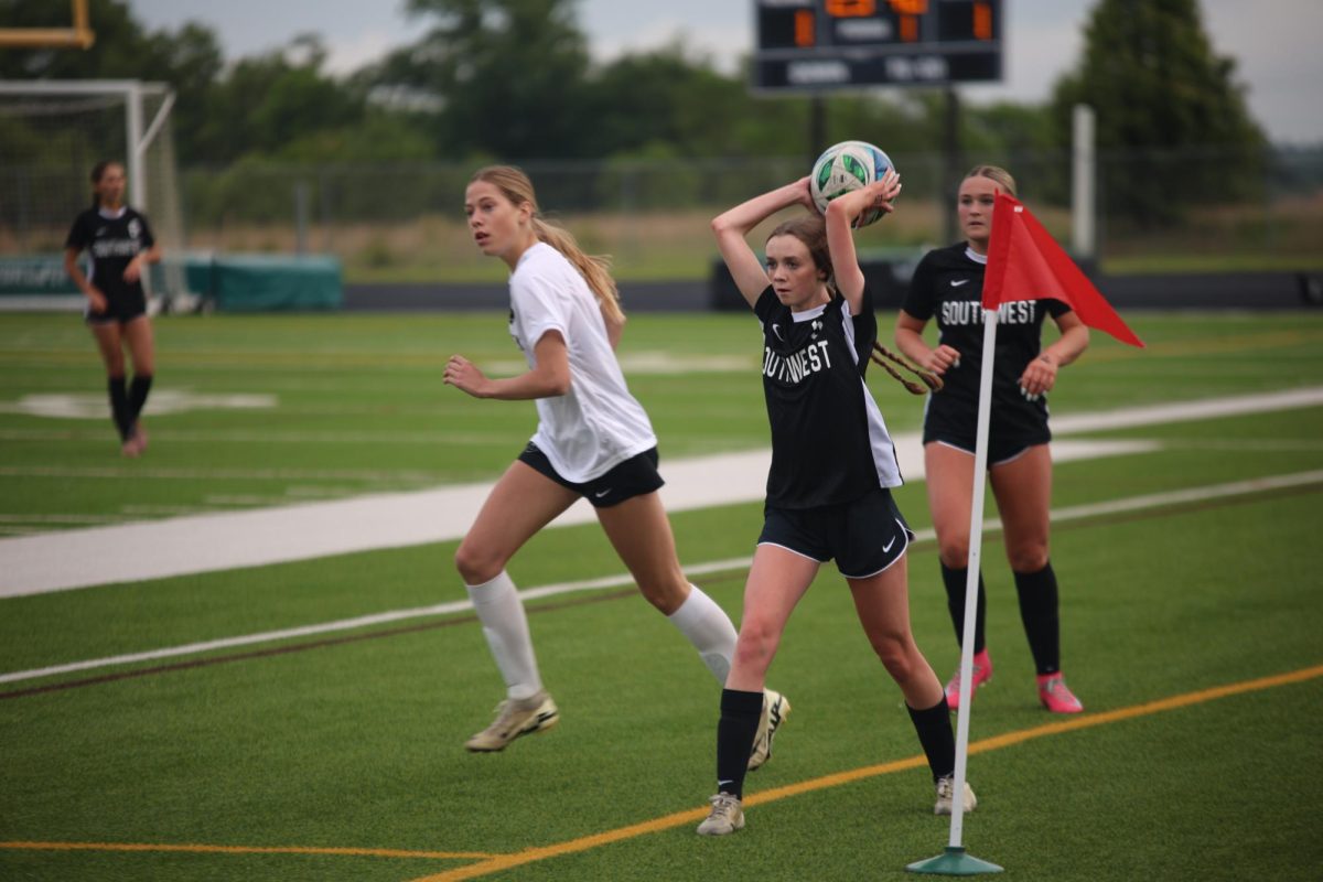 Throwing the ball in, junior Gabby Cowan plays against Blue Valley High on May 5.