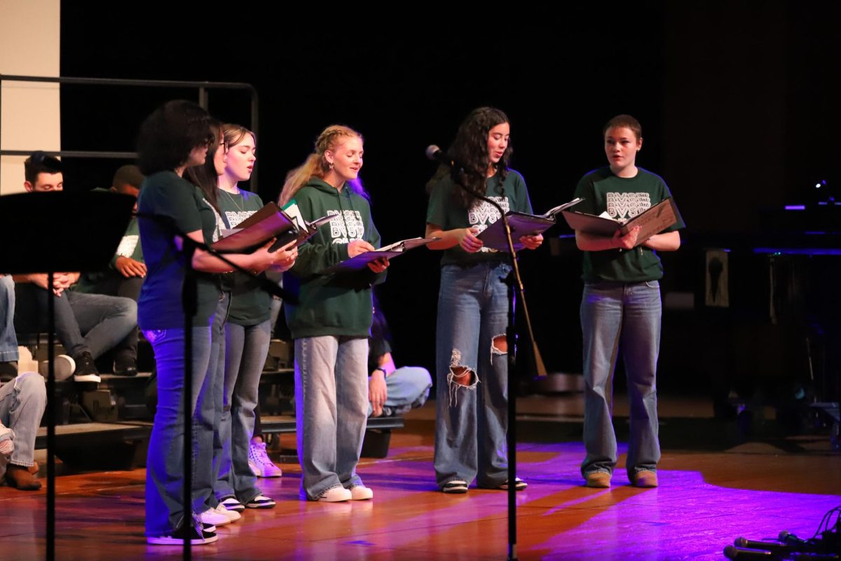 Smiling, the choir performs at a concert on May 12.
