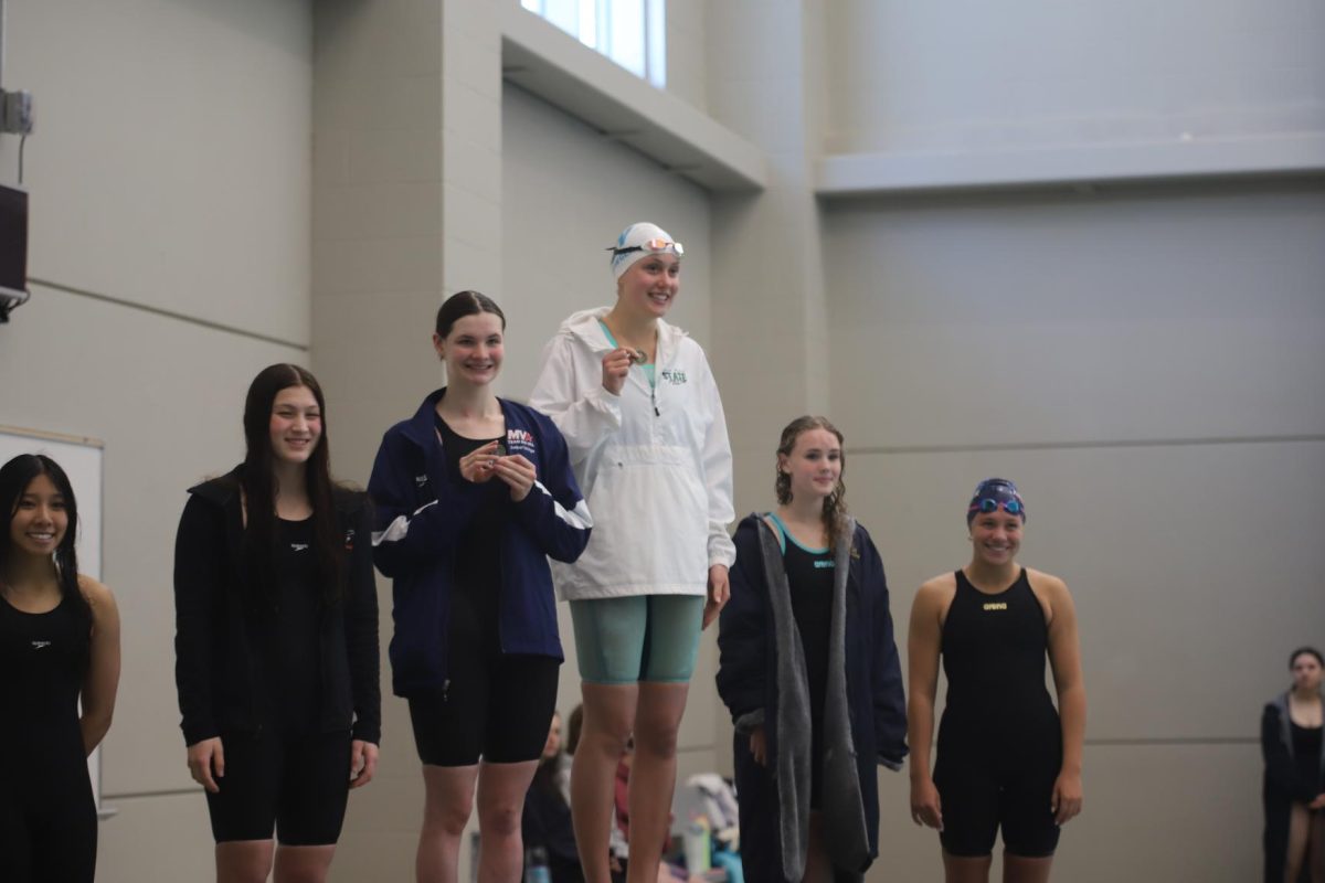 Smiling big, senior Willow Weninger stands on the podium as an EKL champion in her heat on May 9.