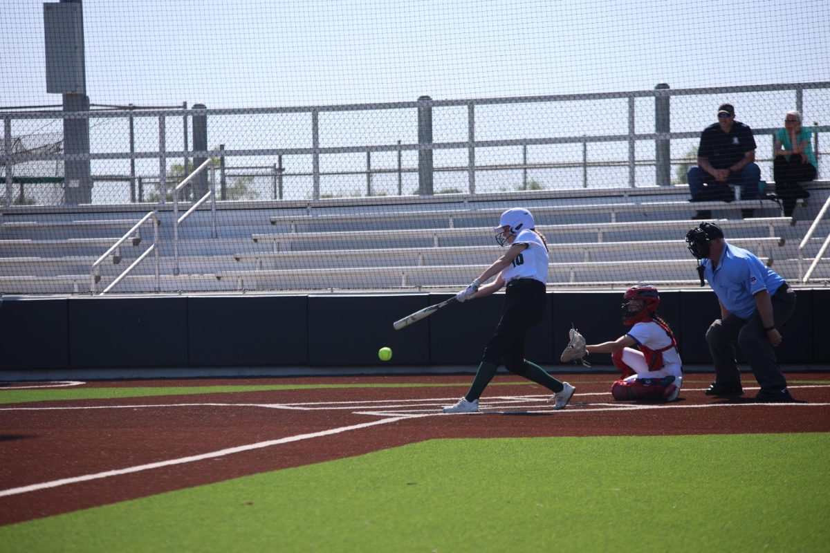 Swinging her bat, senior Sophia Johnson hits the ball on May 11. 