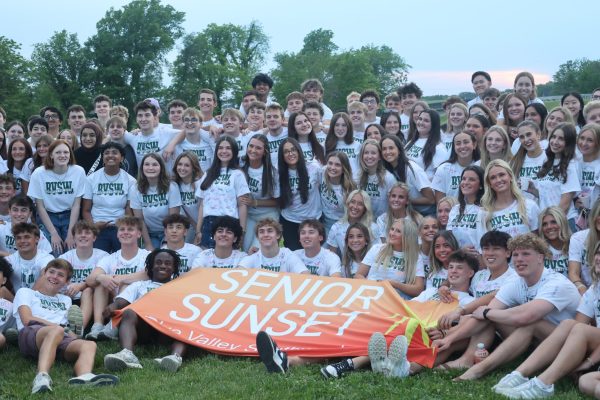 Smiling wide, the class of 2026 seniors take one last photo as a class at the senior sunset on May 14.
