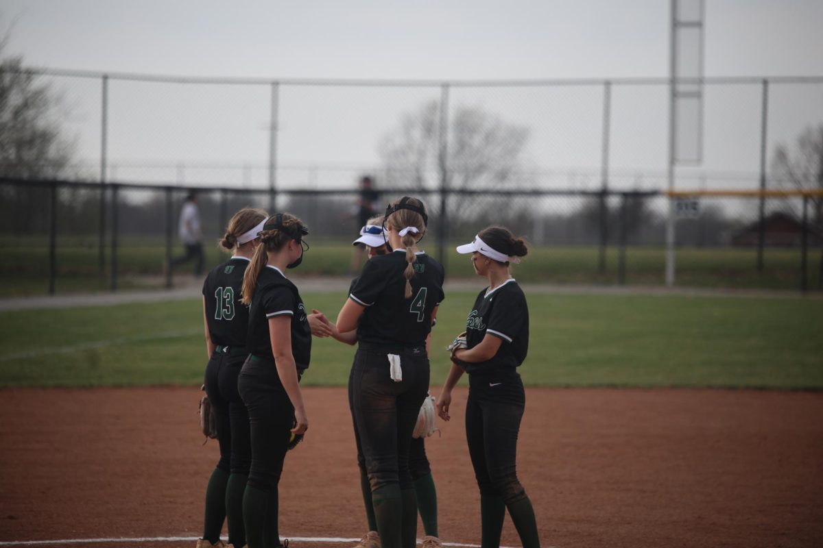 In the huddle, teammates talk about the game.