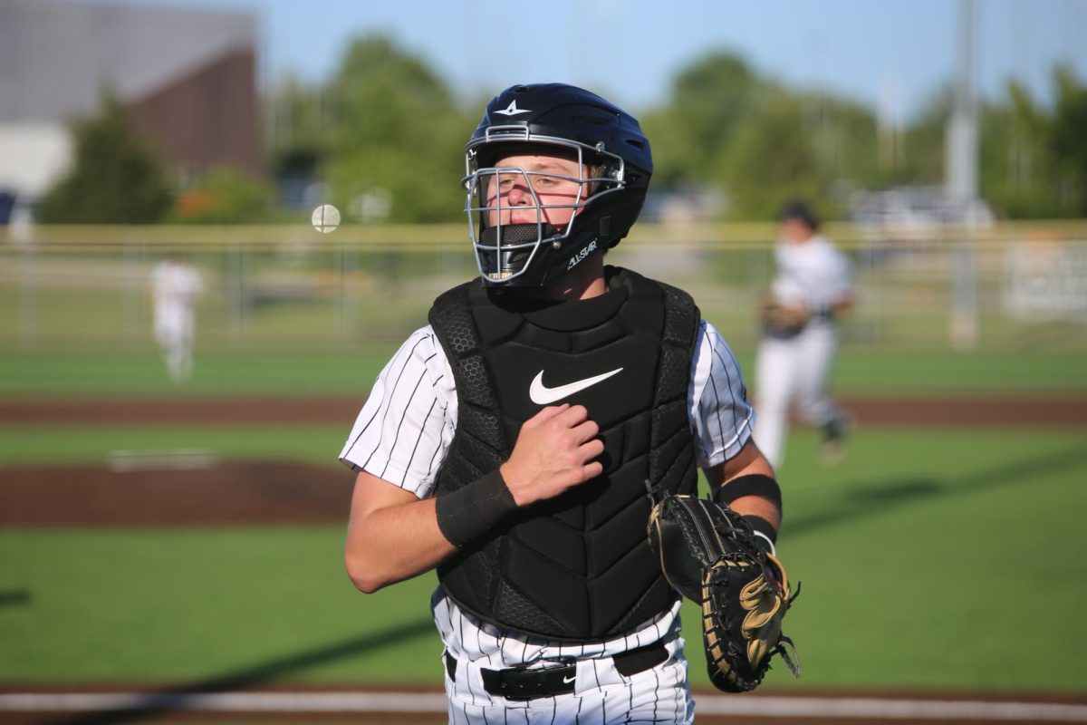 Running to the base, junior Kellan Lang gets in position before the next pitch is thrown on May 11. 