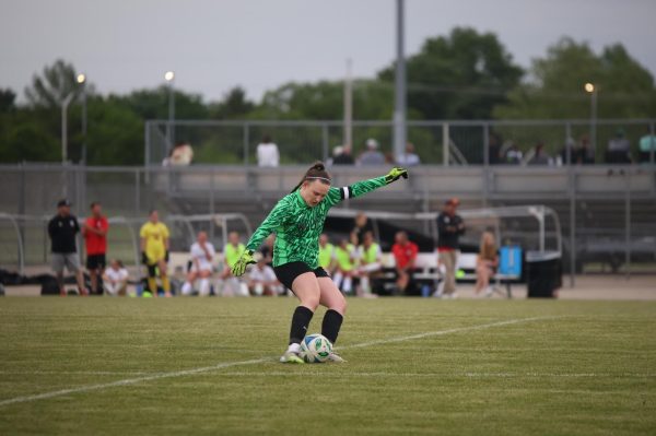 Mid kick, junior Peyton Gillis punts the ball to the team.