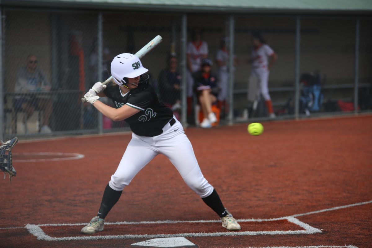 Up to bat, freshman Penelope Peck sets up to swing on May 14. 