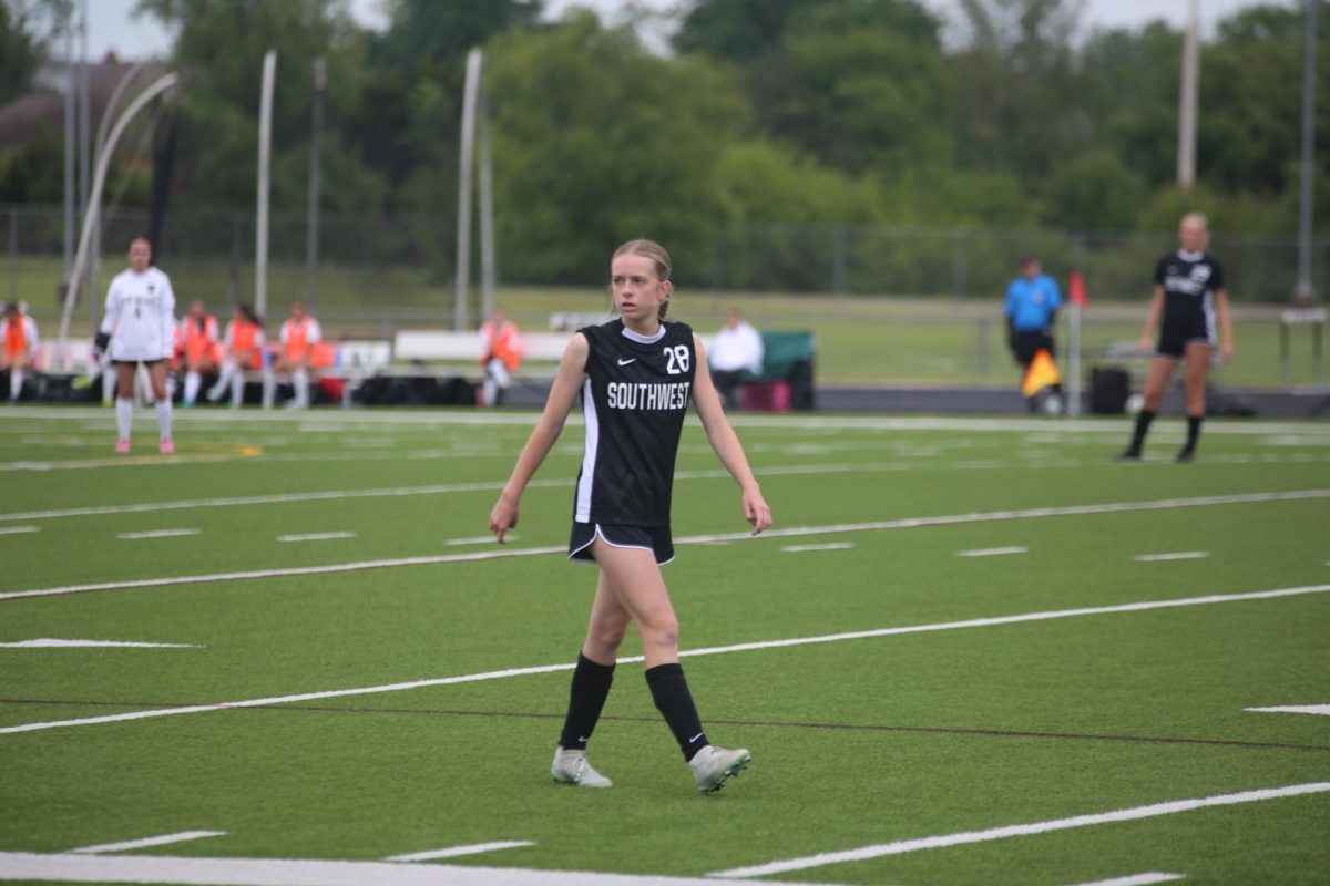 Looking off, freshman Kaelyn Challis plays against Blue Valley High on May 5.