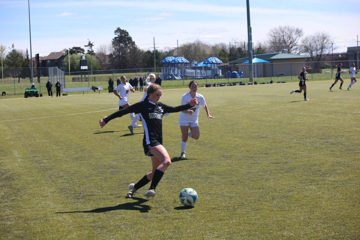 Ball in front, junior Gabby Cowan takes the ball down the field on April 4.